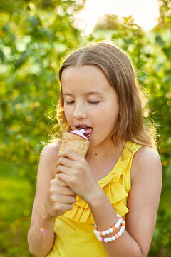 Happy Girl With Braces Eating Italian Ice Cream Cone Smiling While Resting In Park On Summer Day