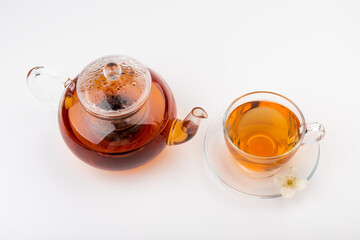 Composition with cup of jasmine tea and flowers on light background