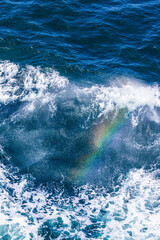 A rainbow seen in the spray of the bow wave of a cruise ship in The Skagerrak off Denmark