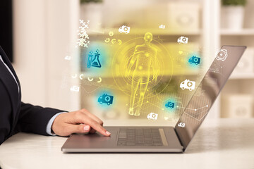 Doctor working on laptop with healthcare concept