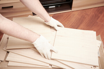 The furniture assembler unpack box with shelf for self assembling. Furniture assembly process at home. DIY Assembling. Close up view