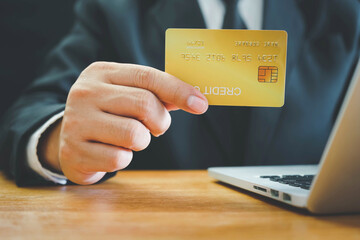 Online payment, Man's Hands holding credit card and using laptop, online credit card payment for purchases from online, Online shopping.	