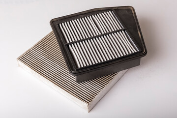 Worn out air filter and car cabin filter. Protection against dirt and dust. Car spare parts concept