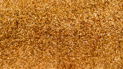 panoramic background texture of flax seeds. linseed  view from above.