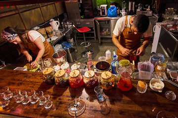 Male and female bartenders are making cocktails