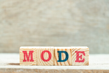 Alphabet letter block in word mode on wood background