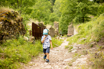 Child, visiting ruins Divci Kamen, Maiden Stone Castle in Czech Republic, near Ceske Budejovice