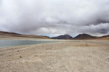 Salt lagunas and volcanos and red rocks southern from San Pedro de Atacama. Stunning scenery at...