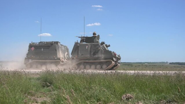 British Army BvS10 Viking all terrain armoured vehicle in action on a military exercise, blue sky