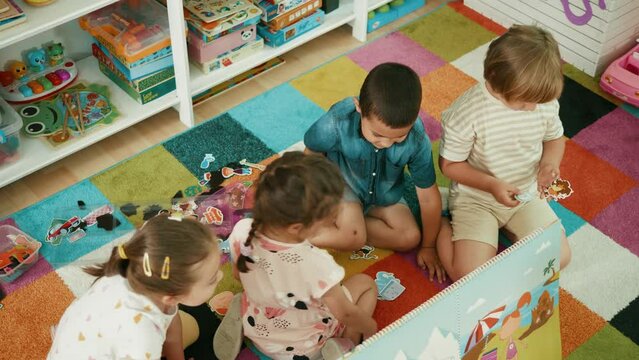 Top view shot of a group diversity kids playing on the carpet in kindergarten
