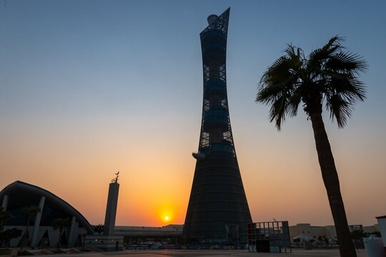 Doha, Qatar &ndash; October 1, 2019: The Torch Tower in Doha Sport City Complex at sunset next to Aspire Masjid Mosque against clear sky