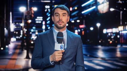 Anchorman Reporting Live News in a City at Night. News Coverage by Professional Handsome Reporter...