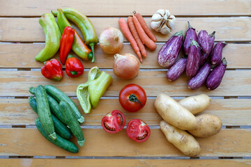 Flat lay raw vegetables on wooden table. Veganism and vegetarianism concepts