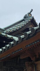 Delicate artistic detail of Japanese shrine &ldquo;Yushima Tenmangu&rdquo; established year 458, 5 petals of sakura as their &ldquo;Kamon (family crest)&rdquo; embedded on the rooftop horn (Toribusuma), photo on 2022/6/14
