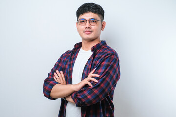 Young handsome man happy face smiling with crossed arms looking at the camera. positive person.