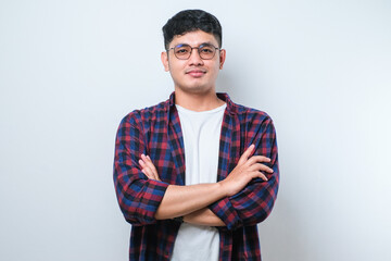 Young handsome man happy face smiling with crossed arms looking at the camera. positive person.