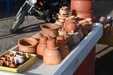 Ceramic clay terracotta jug, pot, vase, kitchen souvenirs on shelf at street handicraft pottery...