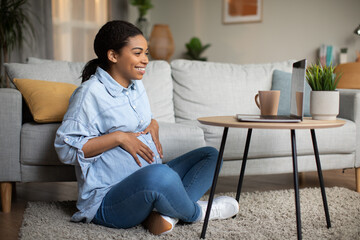 Pregnant African American Female Video Calling Via Laptop At Home