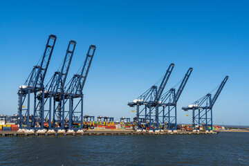 view of containers and harbor cranes at the docks of the international port of Harwich in England