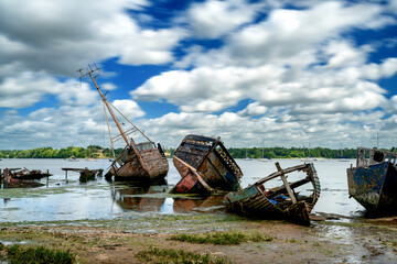 view of the boat graveyard at Pin Mill on the River Orwell in Suffolk at low tide