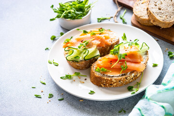 Open sandwich with cream cheese, salmon and cucumber. Healthy breakfast or snack. Top view with copy space.