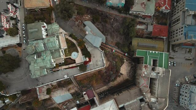 Aerial top down dolly in over Baburizza Palace, Yugoslavian Walk and El Peral funicular in Cerro Alegre, Valparaiso, Chile
