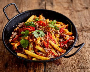 Chilli beef with fries and cilantro