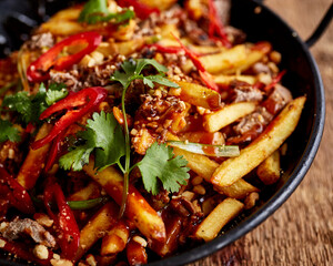 Chilli beef with fries and cilantro