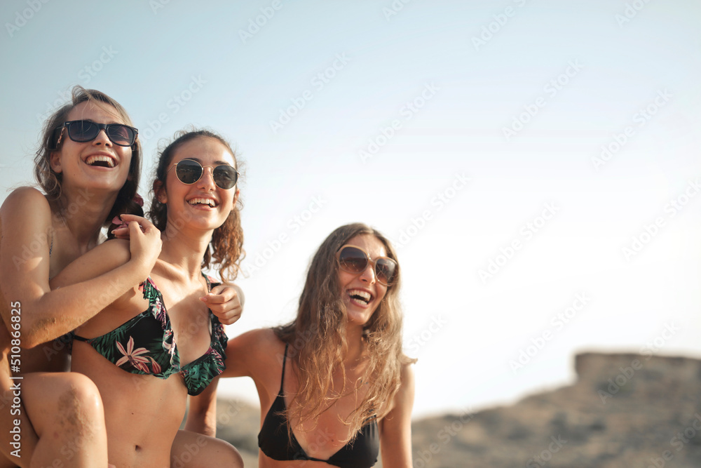 Wall mural group of beautiful girls at the beach