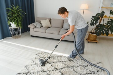 Cleaning concept. woman cleaning carpet with vacuum cleaner.