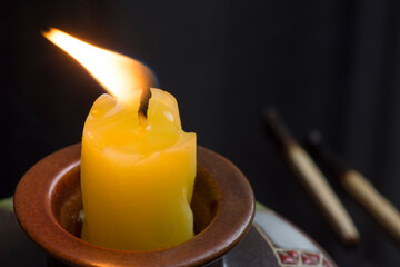 A wax candle burns in a candlestick. Mourning and Memorial Day.