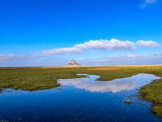 Salt marsh and Mont Saint-Michel landscape in normandy, UNESCO World Heritage Site in France, Europe.