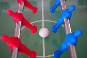 Close up of foosball Table Soccer Game match figures. Football Kicker Game with blue and red...