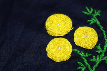 woolen handicraft work with circle frame on cloth