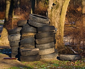 A pile of used tires. Garbage dump. Old car tires. 