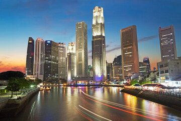 Fototapeta na wymiar Long-exposure of the skyline of the financial hub of Singapore illuminated at twilight