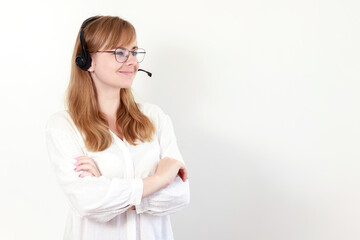 a woman wearing glasses in headphones from the call center on a white background