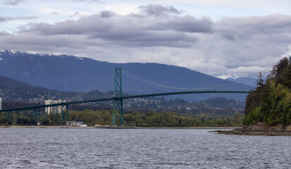 Lions Gate Bridge in a modern city on the West Coast of Pacific Ocean. Vancouver, British Columbia, Canada.