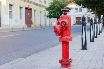 Red fire hydrant on a sidewalk on a public space