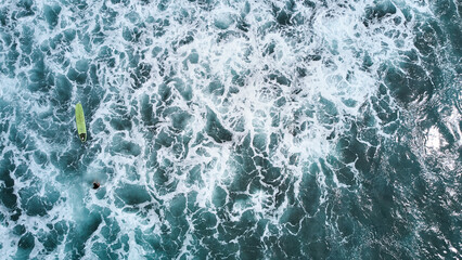 Aerial view of the ocean and surfer girl. Surfing in Midigama. Sri Lanka