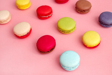 Fototapeta na wymiar Colourful french macaroons or macaron on pink background, Dessert.