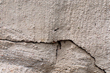crack in the cement wall . A gray concrete wall floor. natural cement or stone old material use for...