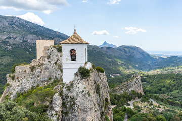 Fototapeta na wymiar Sight of the old bell tower on the top of the rock of the village of Guadalest in Province of Alicante, Spain