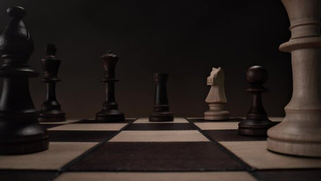 Playing Chess: Chessboard with White Bishop Passing the Camera and Black Rook Moving Vertically in Slow Motion - View from Pawn's Perspective