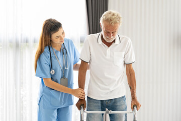Man being cared for by a private Asian nurse at home suffering from Alzheimer's disease to closely...