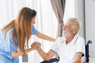 Man being cared for by a private Asian nurse at home suffering from Alzheimer's disease to closely care for elderly patients