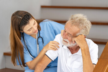 Obraz premium Man being cared for by a private Asian nurse at home suffering from Alzheimer's disease to closely care for elderly patients