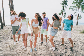 Photo of charming pretty young people wear casual clothes dancing beach festive outside countryside