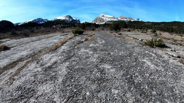 hiking on a rock surface towards mountains D&eacute;voluy, Hautes Alpes, France, AlpsFebruary 2022