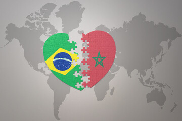 puzzle heart with the national flag of brazil and morocco on a world map background.Concept.
